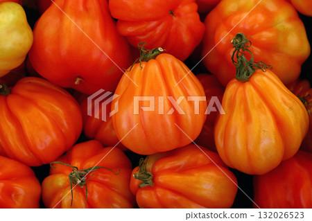 Fresh orange heirloom tomatoes displayed at farmers market Fresh orange heirloom tomatoes displayed at farmers market 132026523