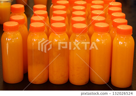 Many plastic bottles of fresh orange juice Many plastic bottles of fresh orange juice 132026524