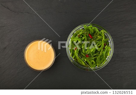 Green wakame seaweed salad with satay sauce 132026551