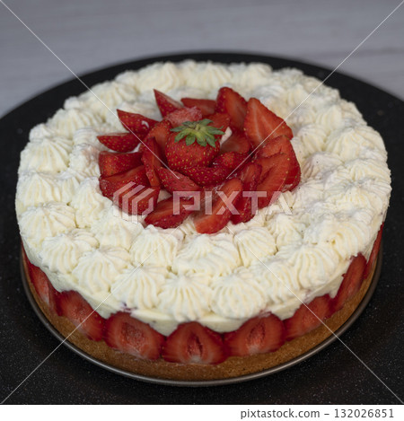 Delightful fraisier cake topped with fresh strawberries and whipped cream Delightful fraisier cake topped with fresh strawberries and whipped cream 132026851