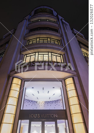 Paris, France - October 04 2025: Illuminated Paris Dior, Louis Vuiton boutique displays fashion 132026877