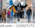 Happy funny person in Halloween grim reaper costume having fun in the mall holding shopping bags 132027173