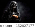 Grim reaper holding pumpkin in the dark 132027177