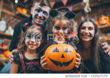 Halloween pumpkins with a happy family in background. 132027179