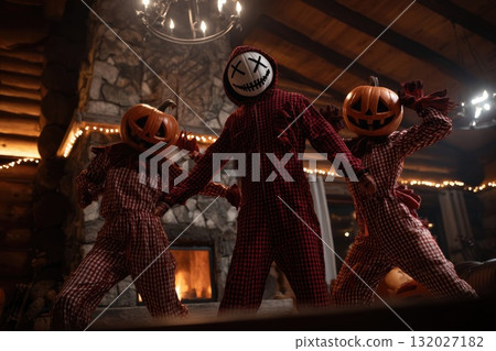 Friends wearing scary costumes dancing in halloween party in a wooden house 132027182