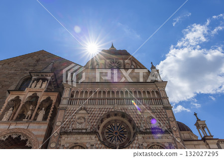 Sunlit Colleoni Chapel facade in Bergamo shows marble arches statues and rose window Sunlit Colleoni Chapel facade in Bergamo shows marble arches statues and rose window 132027295