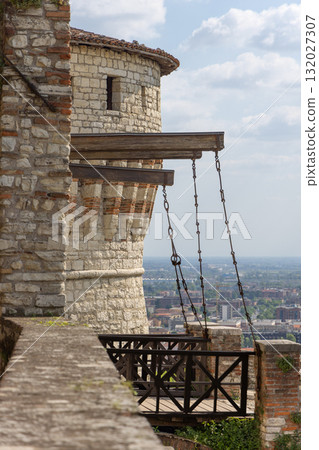 Vertical view of Prisoners Tower fortress walls rise above bright Brescia city landscape Vertical view of Prisoners Tower fortress walls rise above bright Brescia city landscape 132027307