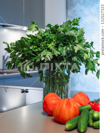 Parsley bouquet with ripe tomatoes and cucumbers on kitchen counter with fresh tones 132027323