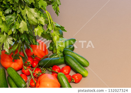 Fresh parsley tomatoes and cucumbers on table with minimal background for copy space 132027324