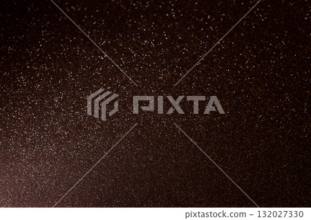 Dark brown glitter with highlights from corner creating dramatic and deep sparkling surface 132027330