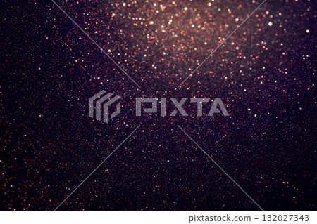 Shimmering deep purple glitter texture detailed below with luminous glow rising at the top 132027343