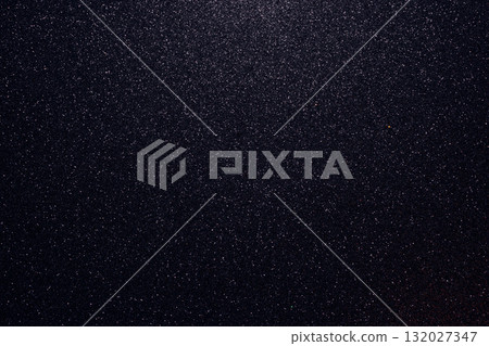 Macro view of dark glitter with gold particles and subtle shadows showing detailed grain texture Macro view of dark glitter with gold particles and subtle shadows showing detailed grain texture 132027347