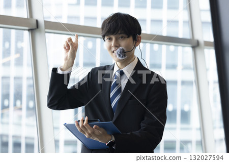 A smiling businessman to guide A smiling businessman to guide 132027594