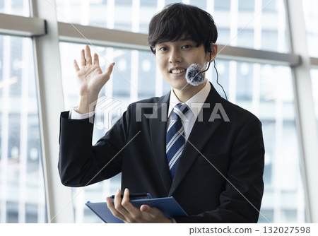 A smiling businessman to guide A smiling businessman to guide 132027598