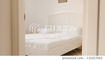 White linen blanket on bed in bedroom at on bright sunny day. 132027663