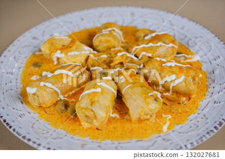 Cabbage rolls sauce Plate with tasty stuffed cabbage rolls and sauce on light wooden background 132027681