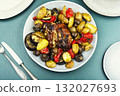 Baked or braised meat with vegetables. 132027693