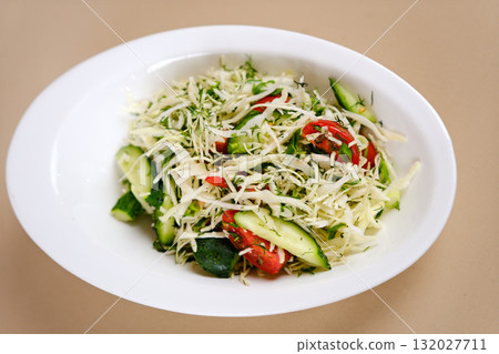 Vegetarian salad. Spring vegan salad with cabbage, cucumber, green onion and parsley. Top view, flat lay, overhead Vegetarian salad. Spring vegan salad with cabbage, cucumber, green onion and parsley. Top view, flat lay, overhead 132027711
