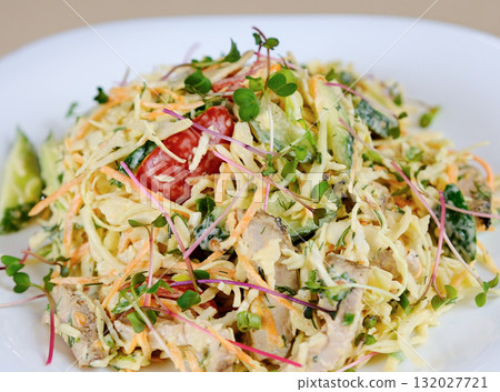 There is salad of chopped fresh vegetables on plate. Dish is made from salad pim , cabbage, bell pepper, corn and seasoned with mayonnaise 132027721