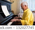 Elderly composer composes music and plays piano at home 132027745