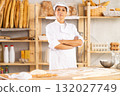 Mature woman baker posing in bakery 132027749