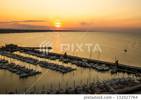 Yacht club. The sky in the evening. Water sea parking ships. Sunset sky at seaport of Italian city of Rimini in Summer. Yacht club. The sky in the evening. Water sea parking ships. Sunset sky at seaport of Italian city of Rimini in Summer. 132027764