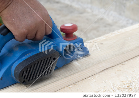 Worker is planing boards Worker is planing boards 132027957