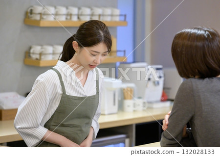 A cafe employee dealing with a customer's complaint 132028133