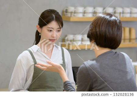 A cafe employee dealing with a customer's complaint A cafe employee dealing with a customer's complaint 132028136