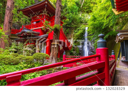 A fantastical temple and waterfall surrounded by fresh greenery A fantastical temple and waterfall surrounded by fresh greenery 132028329