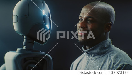 Man Smiling Warmly While Looking Futuristic AI Robot With Glowing Accents Man Smiling Warmly While Looking Futuristic AI Robot With Glowing Accents 132028384