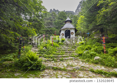 Symbolic cemetery with chapel and painted crosses in Vysoke Tatry Symbolic cemetery with chapel and painted crosses in Vysoke Tatry 132028645