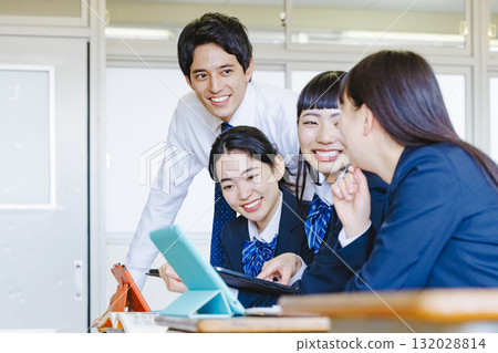 High school girl and male teacher studying in the classroom 132028814