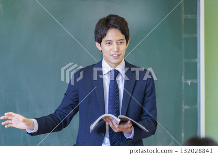 A male teacher talking with a smile A male teacher talking with a smile 132028841