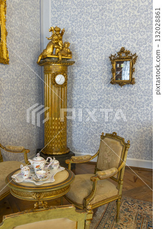 Baroque interior with cherub clock and tea set Baroque interior with cherub clock and tea set 132028861