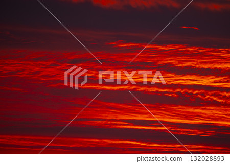 Evening sky displaying dramatic red and crimson clouds Evening sky displaying dramatic red and crimson clouds 132028893