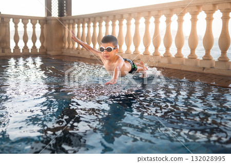 Child Diving Into Clear Pool Water With Joy And Enthusiasm 132028995