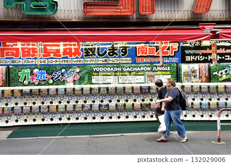 Gashapon machines lined up in front of a camera shop at Shinjuku West Exit 132029006