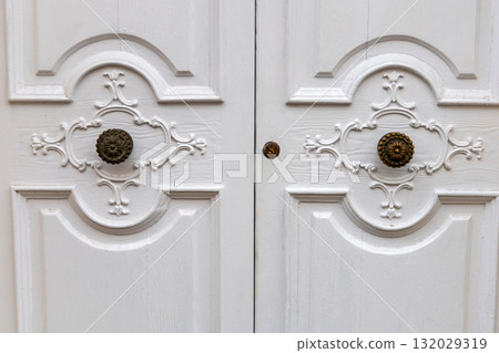 Closed decorative white doors with carved pattern Closed decorative white doors with carved pattern 132029319