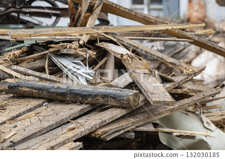 Demolition activity at a construction site reveals dismantled building materials in a cluttered pile Demolition activity at a construction site reveals dismantled building materials in a cluttered pile 132030185