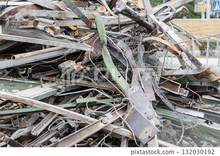 Demolition site with dismantled building materials piled high during construction project in urban area Demolition site with dismantled building materials piled high during construction project in urban area 132030192