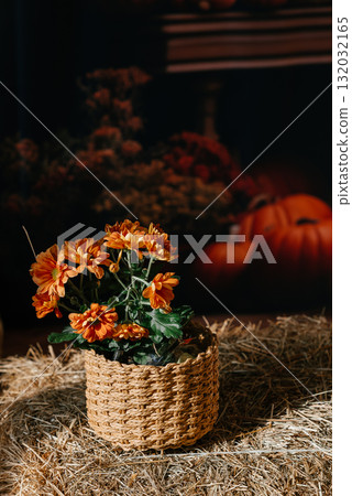 Rustic Basket with Orange Flowers on Straw Background Rustic Basket with Orange Flowers on Straw Background 132032165