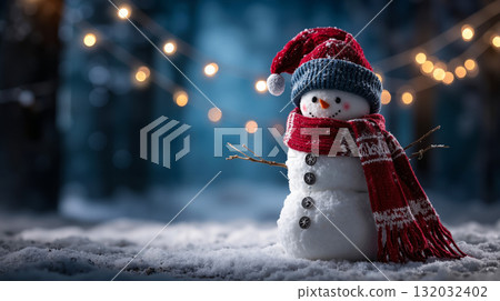 A snowman wearing a red hat and scarf in the snow 132032402
