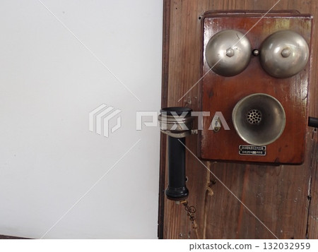 Old wall-mounted telephone 132032959