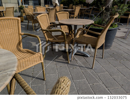 wooden tables and wicker chairs 132033075