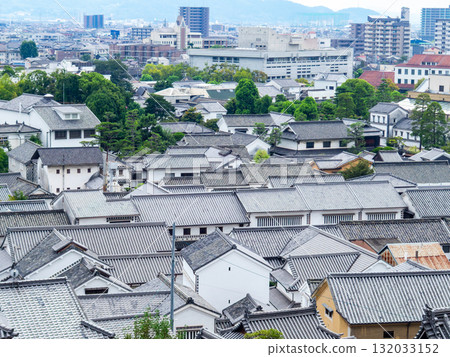 The historical and picturesque streets of Kurashiki Bikan Historical Quarter: View of Kurashiki's tiled roofs from the top of a hill 132033152