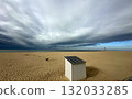 A Serene Beach Landscape Appearing Beneath Dramatic Clouds and Captivating Skies 132033285