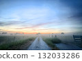 Enjoy the serene morning landscape characterized by enchanting fog and a brilliant sunrise 132033286