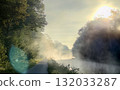 At Sunrise, the Misty River is Surrounded by Beautiful Lush Foliage and Natures Splendor 132033287