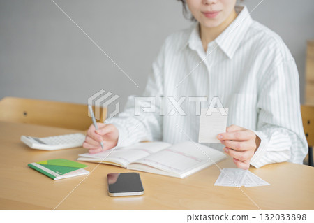 A woman holding a household account book A woman holding a household account book 132033898